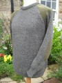 Hand framed crew neck sweater in green derby tweed mix with patches on shoulders and elbows.